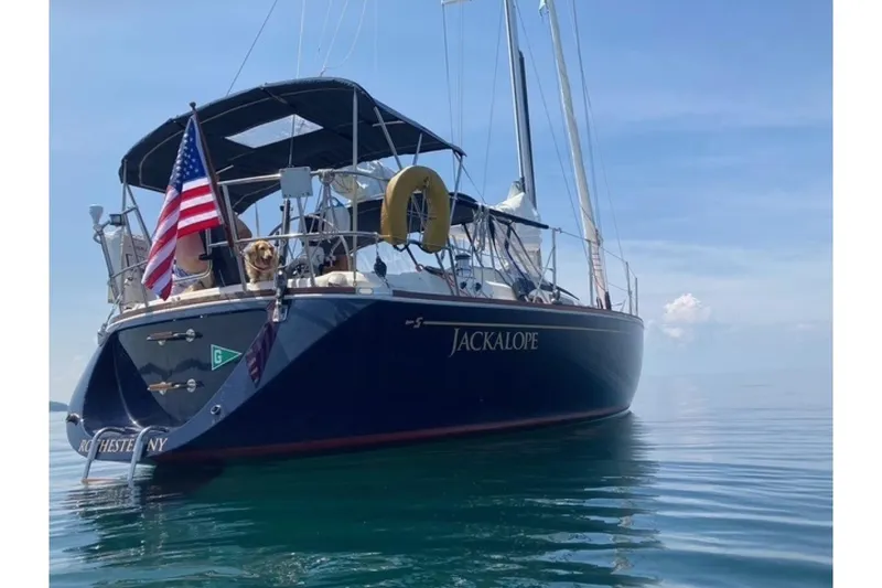 Slide: The Image of Sailboat "Jackalope" on calm water, Sabre 362, 1994 model, with American flag. - 5