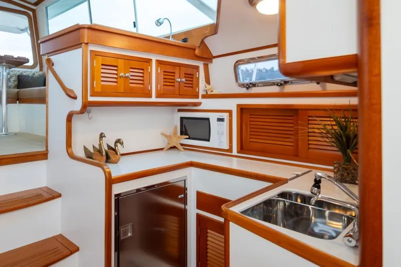 Slide: The Image of 2007 Bruckmann BLUESTAR yacht interior with wooden cabinetry, sink, and microwave. - 17