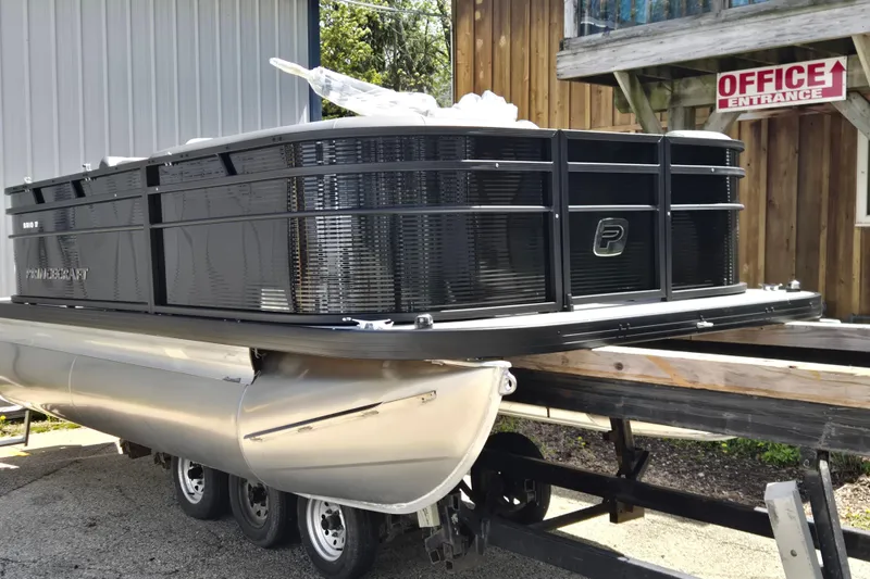 The Image of 2026 Princecraft Brio 17 Electric pontoon boat on trailer near office entrance. - 0