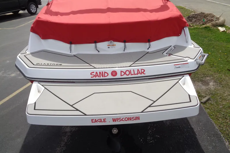 Slide: The Image of 2022 Glastron GX 215 boat with red cover, labeled "Sand Dollar," located in Eagle, Wisconsin. - 7