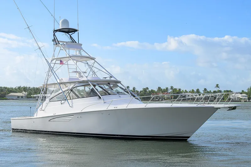 Slide: The Image of 2015 Viking 52 Open yacht cruising on calm waters under a clear blue sky. - 4