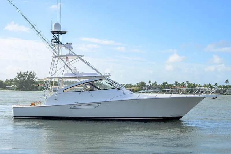 Slide: The Image of 2015 Viking 52 Open yacht cruising on calm waters under a clear blue sky. - 5