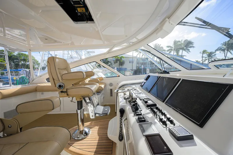 Slide: The Image of Luxurious helm of 2015 Viking 52 Open yacht with advanced navigation controls and leather seating. - 50