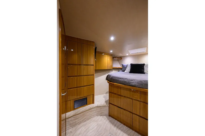 Slide: The Image of Luxurious cabin interior of 2015 Viking 52 Open yacht with wood cabinetry and cozy bedding. - 58