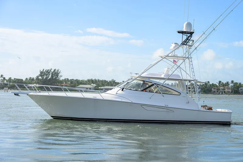 Slide: The Image of 2015 Viking 52 Open yacht cruising on calm waters under a clear blue sky. - 8