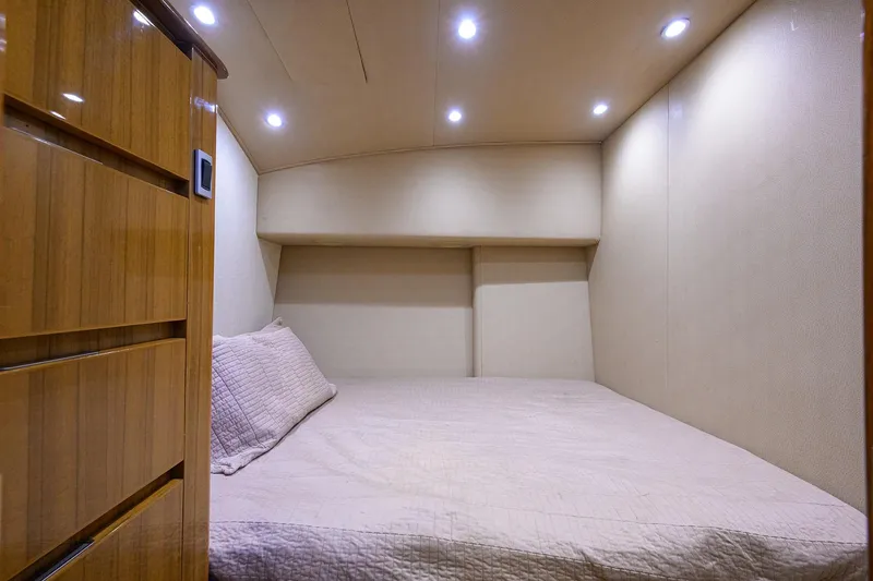 Slide: The Image of Cozy cabin interior of 2015 Viking 52 Open yacht with soft lighting and wooden accents. - 81
