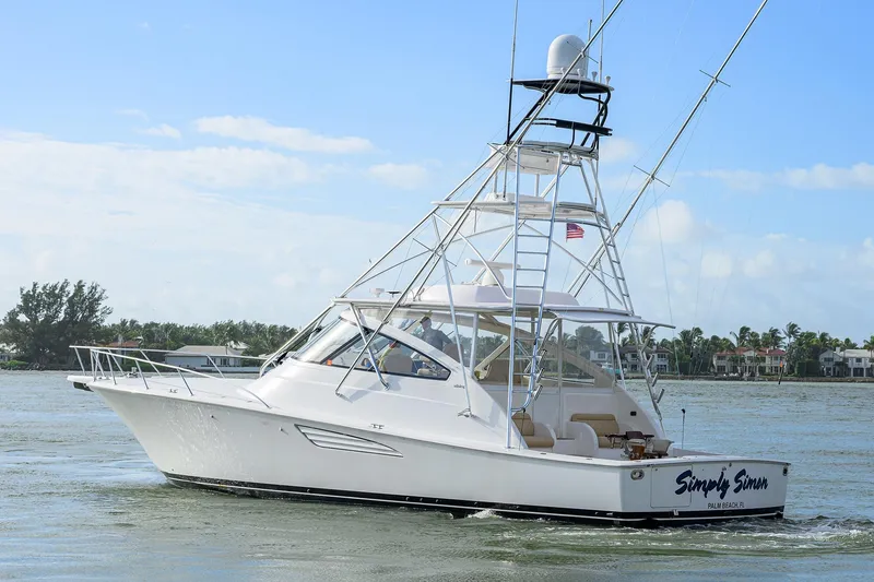 Slide: The Image of 2015 Viking 52 Open yacht cruising on a sunny day near coastal homes. - 9