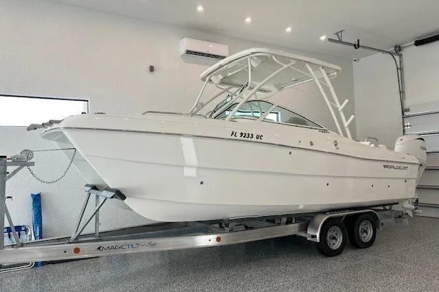 The Image of 2026 World Cat 230 SD boat on trailer in a garage setting. - 0
