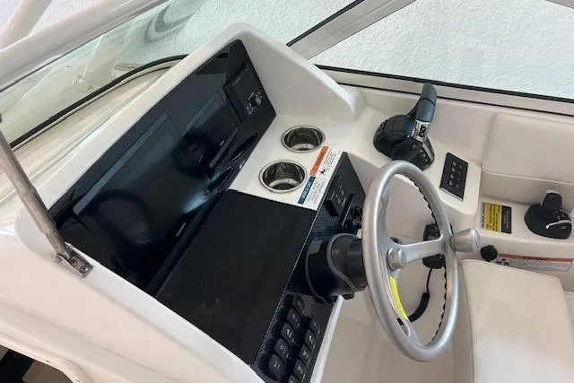 Slide: The Image of Helm of 2026 World Cat 230 SD boat with steering wheel and controls. - 11