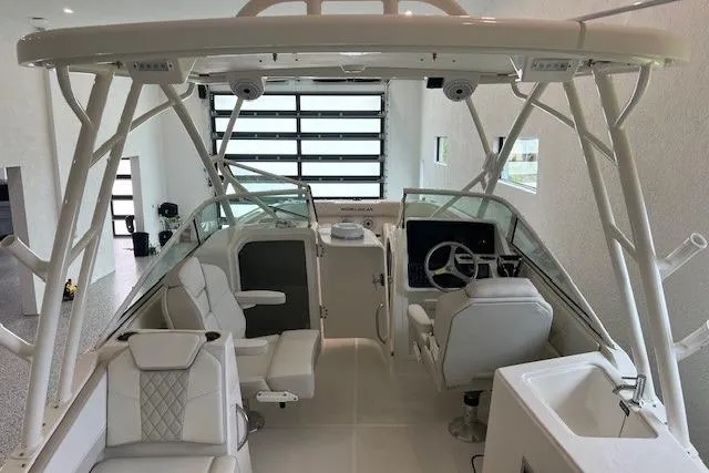 Slide: The Image of 2026 World Cat 230 SD boat interior with modern seating and steering console. - 13