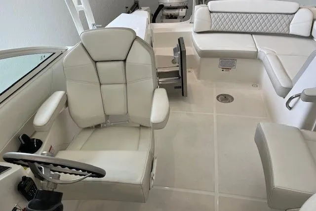 Slide: The Image of Interior of 2026 World Cat 230 SD boat with white seating and steering wheel. - 4