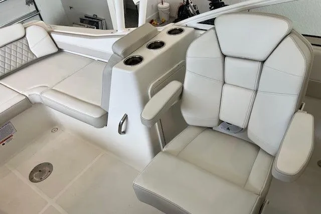 Slide: The Image of Luxury seating on 2026 World Cat 230 SD boat with cup holders and white upholstery. - 5