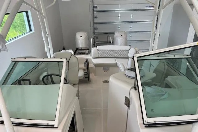 Slide: The Image of 2026 World Cat 230 SD boat interior with dual consoles and seating in a garage setting. - 6