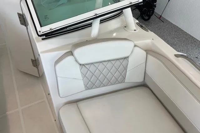 Slide: The Image of 2026 World Cat 230 SD boat interior with white cushioned seating and diamond-patterned backrest. - 7