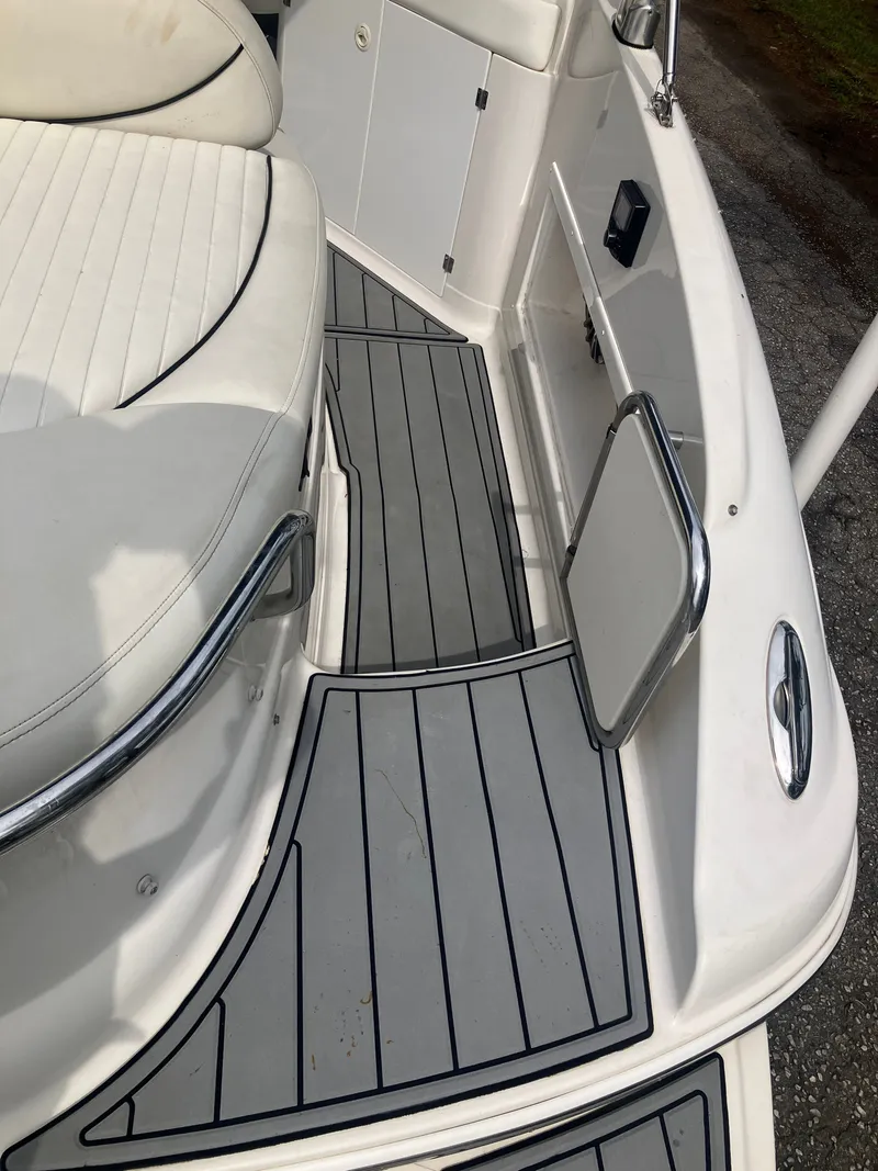 Slide: The Image of Interior of a 2006 Monterey 263 ES boat with white seating. - 10