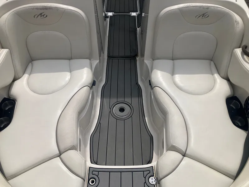 Slide: The Image of Interior of a 2006 Monterey 263 ES boat with white seating. - 19