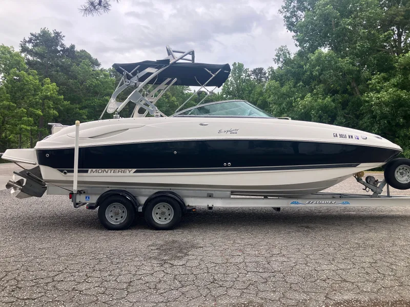 Slide: The Image of 2006 Monterey 263 ES boat parked on trailer outdoors. - 4