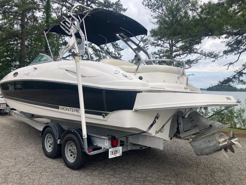 Slide: The Image of 2006 Monterey 263 ES boat on trailer, parked by lakeside. - 7