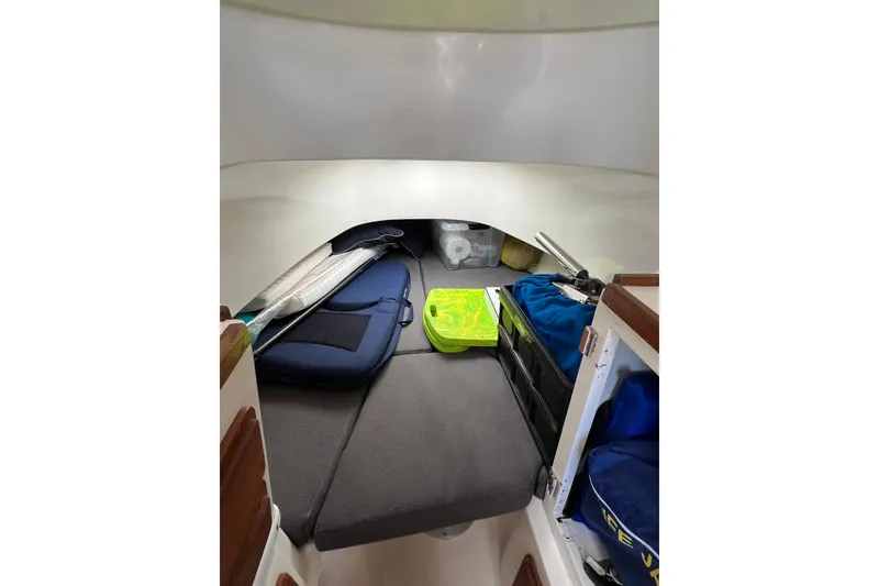 Slide: The Image of Interior cabin of a 2005 Contender 31 Fisharound boat with storage and cushions. - 11