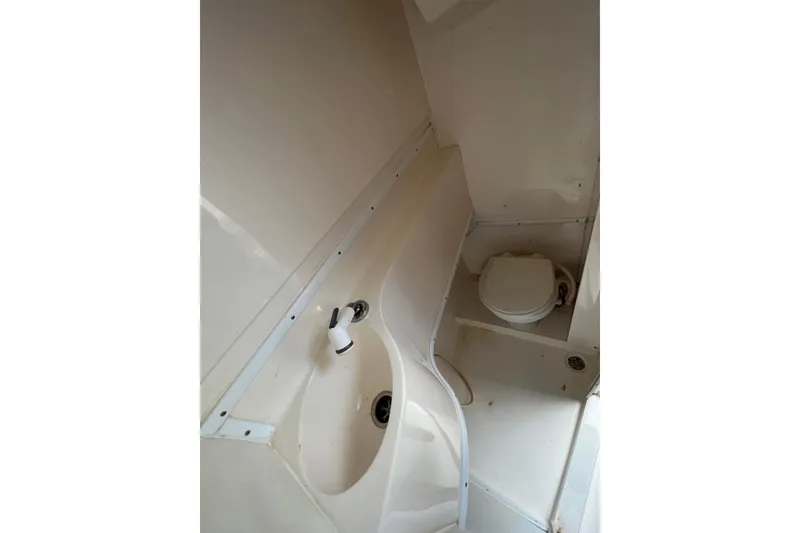 Slide: The Image of 2005 Contender 31 Fisharound boat bathroom with sink and toilet. - 12