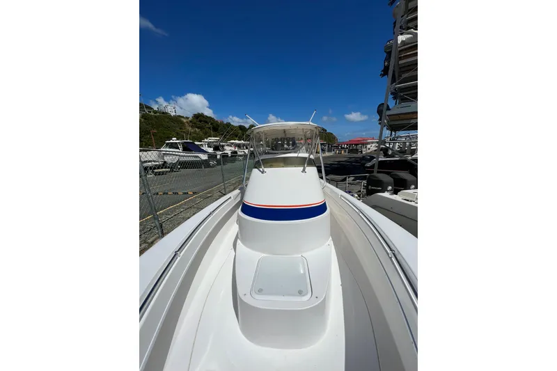 Slide: The Image of 2005 Contender 31 Fisharound boat docked under clear blue sky. - 13