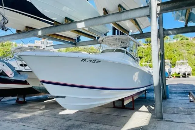 Slide: The Image of 2005 Contender 31 Fisharound boat on dry dock, white hull, sunny day. - 2