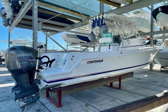 Slide: The Image of 2005 Contender 31 Fisharound boat with Yamaha outboard motor in dry storage. - 3
