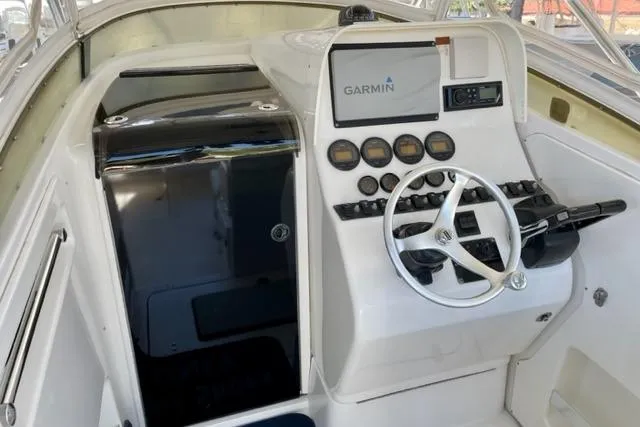 Slide: The Image of 2005 Contender 31 Fisharound helm with Garmin navigation system and steering wheel. - 5
