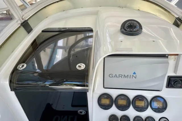 Slide: The Image of Console of a 2005 Contender 31 Fisharound with Garmin navigation and compass. - 6