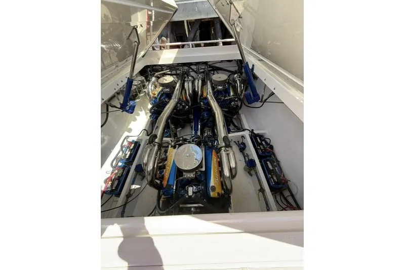 Slide: The Image of Engine compartment of a 2000 Fountain 47 Lightning boat, showcasing dual engines and components. - 10