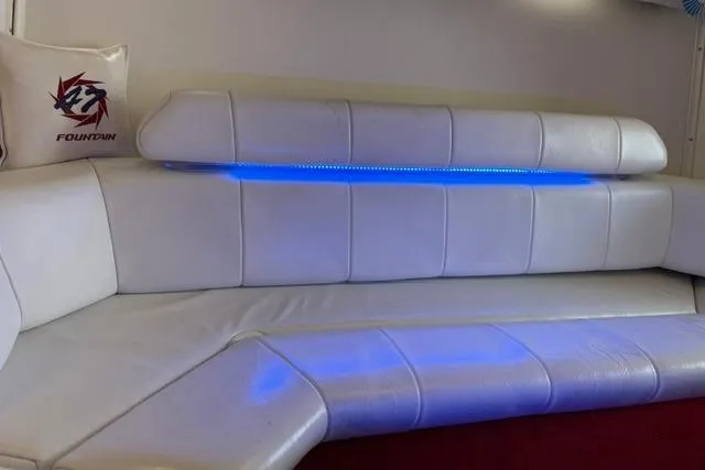 Slide: The Image of White leather seating with blue LED lighting in a 2000 Fountain 47 Lightning boat. - 11