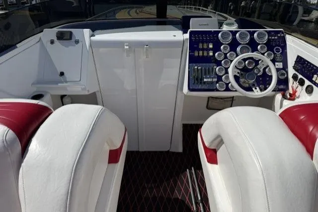 Slide: The Image of Cockpit of 2000 Fountain 47 Lightning boat with white and red seating, detailed dashboard. - 12