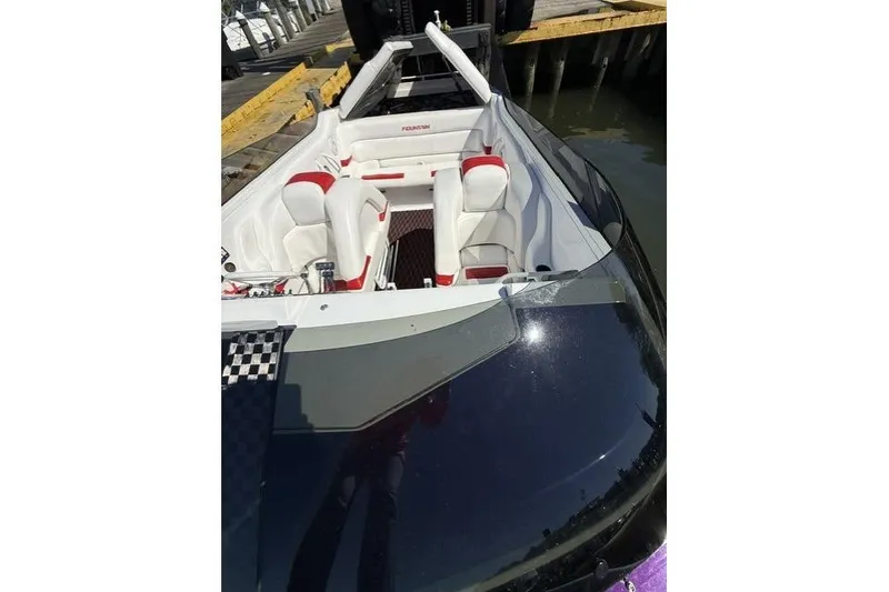 Slide: The Image of 2000 Fountain 47 Lightning boat with white and red interior docked at marina. - 14