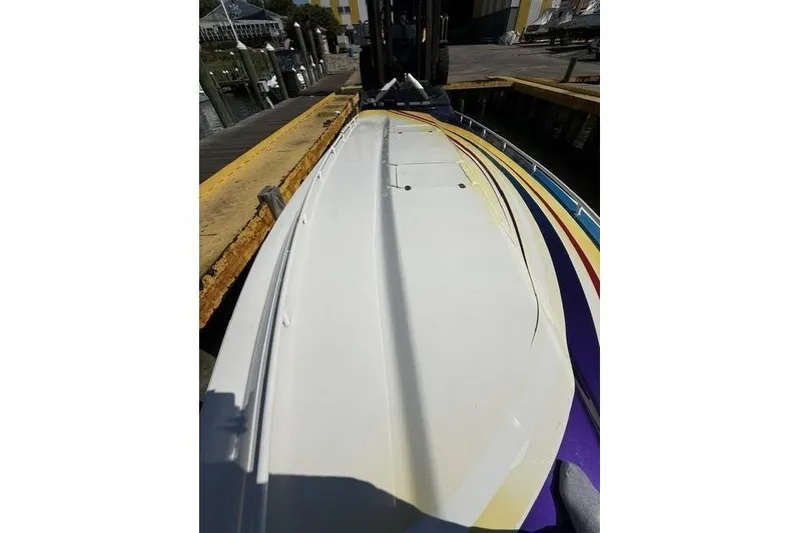 Slide: The Image of 2000 Fountain 47 Lightning boat on dock, showcasing sleek design and vibrant colors. - 15