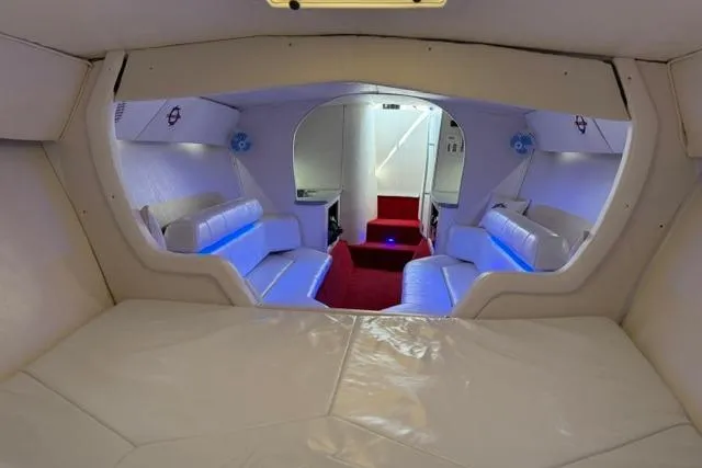 Slide: The Image of Interior of 2000 Fountain 47 Lightning boat with white seating and blue accent lighting. - 17