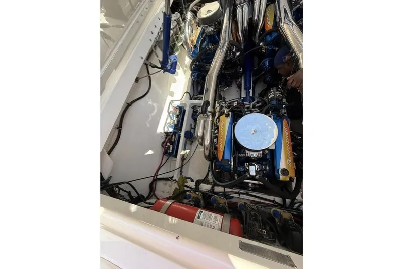 Slide: The Image of Engine compartment of a 2000 Fountain 47 Lightning boat, showcasing detailed mechanical components. - 18