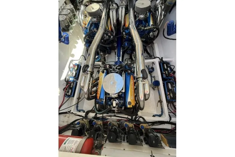 Slide: The Image of Engine compartment of a 2000 Fountain 47 Lightning boat, showcasing dual high-performance engines. - 19