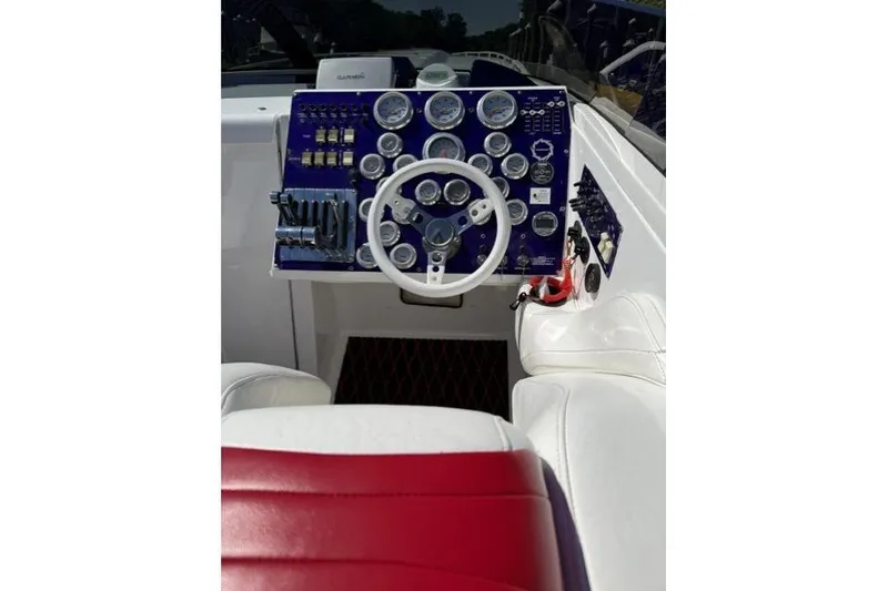 Slide: The Image of Cockpit of a 2000 Fountain 47 Lightning boat with gauges and steering wheel. - 22