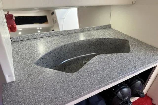 Slide: The Image of Gray speckled countertop with integrated sink in 2000 Fountain 47 Lightning boat. - 26