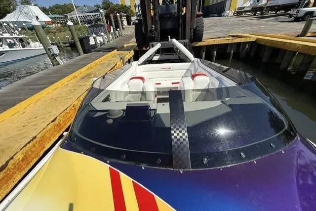Slide: The Image of 2000 Fountain 47 Lightning speedboat docked, showcasing sleek design and vibrant colors. - 27