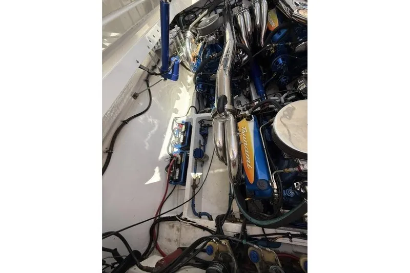 Slide: The Image of Engine compartment of a 2000 Fountain 47 Lightning boat, showcasing detailed components and wiring. - 28