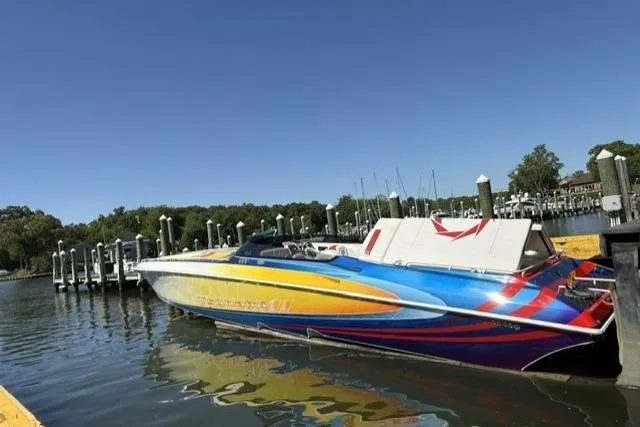 Slide: The Image of Colorful 2000 Fountain 47 Lightning speedboat docked at a marina under clear blue skies. - 3