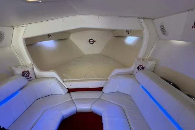Slide: The Image of Interior of a 2000 Fountain 47 Lightning boat with white seating and ambient lighting. - 30