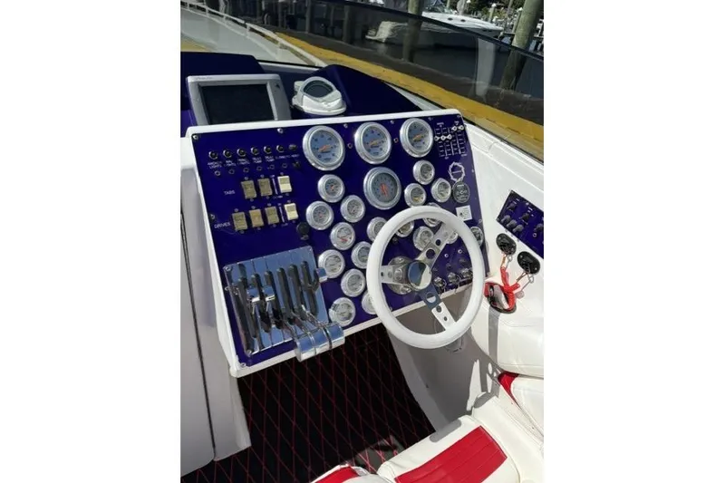 Slide: The Image of Cockpit of a 2000 Fountain 47 Lightning boat with gauges and controls. - 33