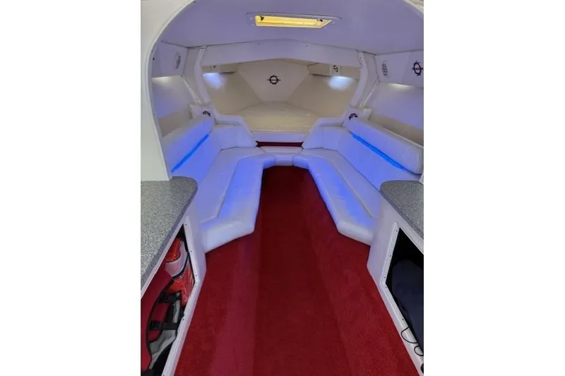 Slide: The Image of Interior of 2000 Fountain 47 Lightning boat with white seating and red carpet. - 34