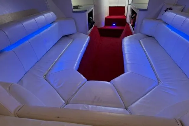 Slide: The Image of Interior of 2000 Fountain 47 Lightning boat with white leather seating and blue accent lighting. - 35