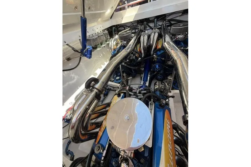 Slide: The Image of Engine compartment of a 2000 Fountain 47 Lightning boat, showcasing polished components. - 37