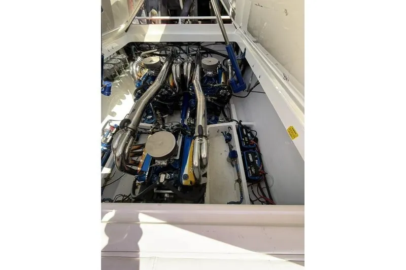 Slide: The Image of Engine compartment of a 2000 Fountain 47 Lightning boat, showcasing powerful machinery. - 39