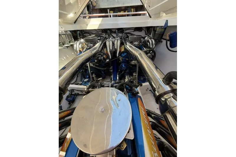 Slide: The Image of Engine compartment of a 2000 Fountain 47 Lightning boat, showcasing polished components. - 40