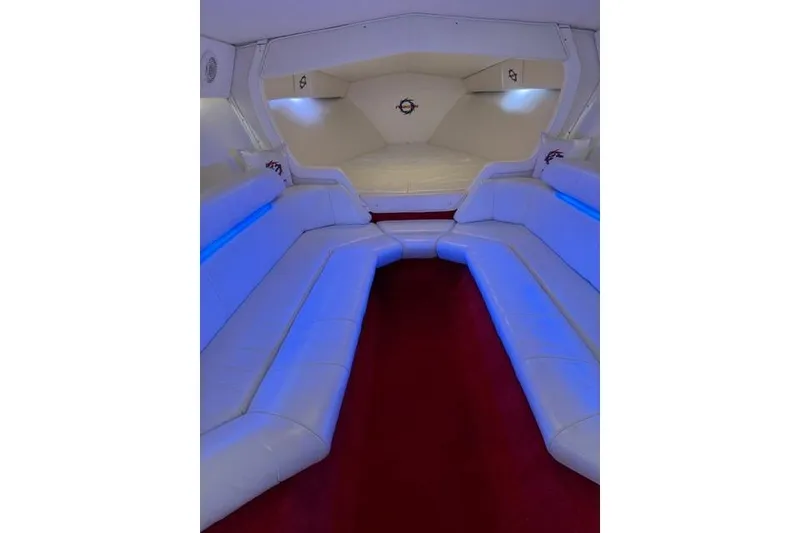 Slide: The Image of Luxurious interior of a 2000 Fountain 47 Lightning boat with white seating and blue lighting. - 42